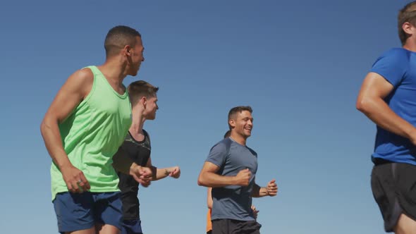 Men running outside on sunny day