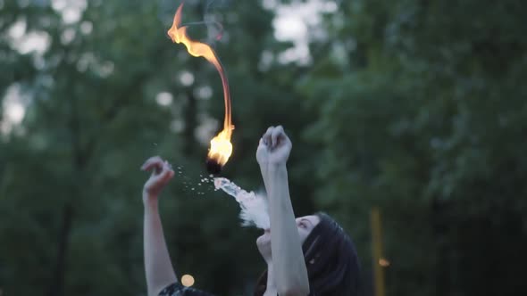 Cute Young Grace Girl Performing a Show with Flame Standing in Front of Forest