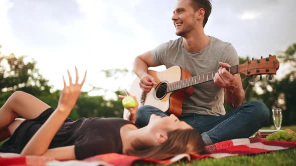 Young Beautiful Couple Smiling Resting in Park