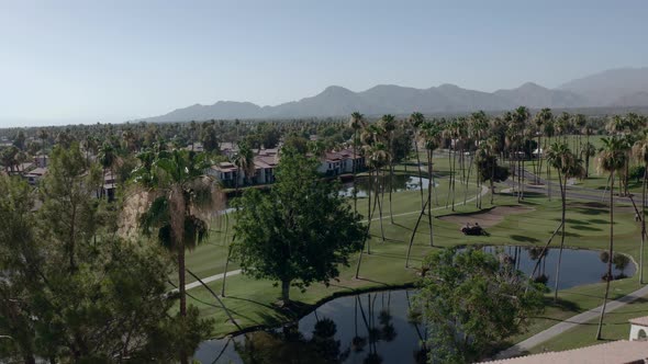 Tilt down shot of Luxury Houses of a resort with golf course and small ponds in Palm Springs, Califo