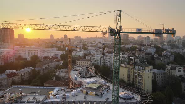 Construction Crane on a Construction Site in the City at Sunrise. Kyiv, Ukraine. Aerial View