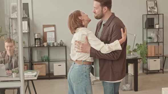 Man and Woman Greeting in Office