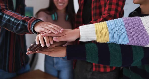 Young people stacking hands together - Lifestyle and school concept