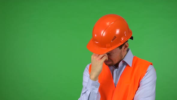 A Young Handsome Construction Worker Acts Sad - Green Screen Studio