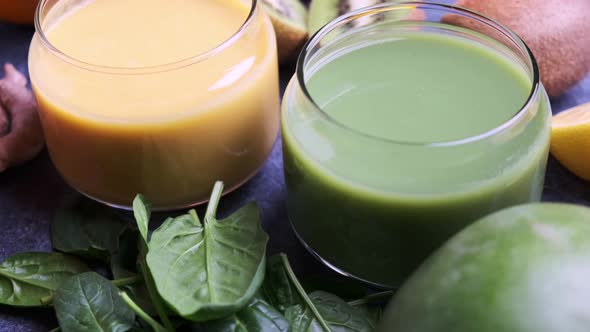 Yellow mango smoothie and green spinach smoothie