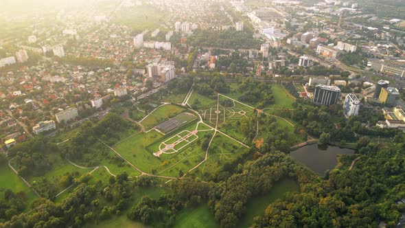 Aerial drone view of Chisinau. Park with lush greenery and lake. Panorama view of multiple buildings