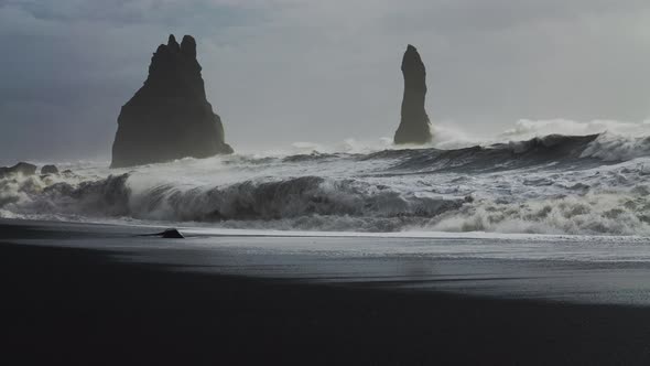 Misty Sea Stacks And Crashing Sea On Black Sand Beach