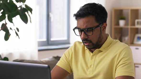 Tired Man with Laptop Working at Home Office