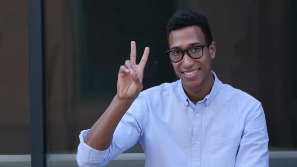 Gesture of Success, Victory Sign by Young Black Handsome Man