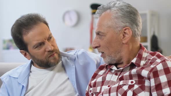 Grey-Bearded Father Telling Stories From Life to His Middle-Aged Son, Relations
