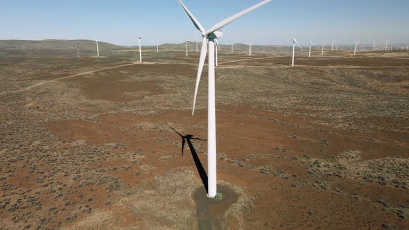 Renewable Energy Equipment Aerial With Turbines Rotating At Wind Farm In Washington