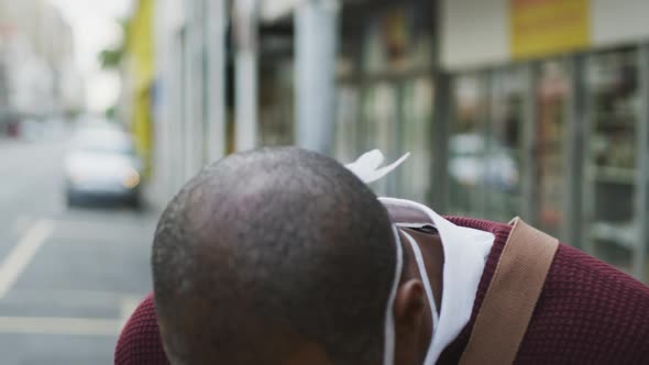 African american man on the go wearing coronavirus covid19 mask