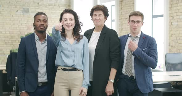 Group of Multiracial Coworkers Posing in Office. Positive Confident African American and Caucasian