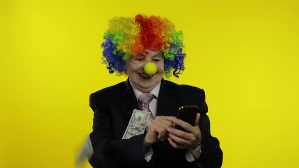 Clown Businesswoman Freelancer Receives Money Income While Using Smartphone