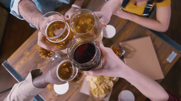 Men clinking glasses with beer