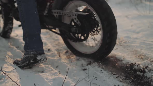 Man Biker Doing Tire Burnout in the Snow Field Slow Motion