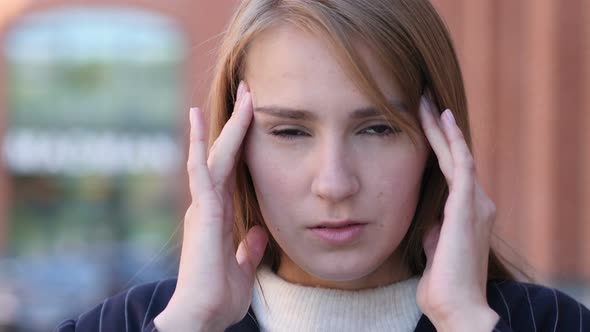 Tense Businesswoman with Headache Standing Outside Office