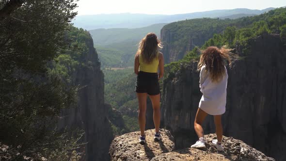 Hikers Enjoy View of Ancient Mountains Standing on Stones