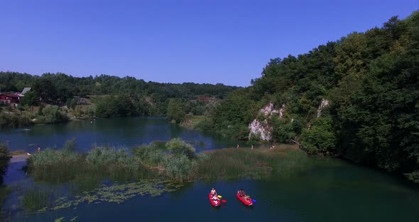 Aerial view of friends enjoying in a canoe on sunny day