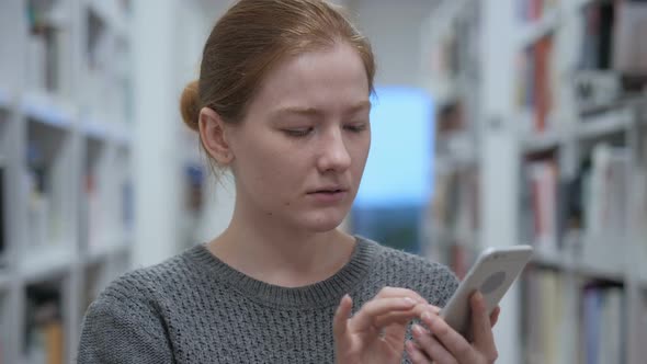 Young Woman Using Smartphone for Online Browsing