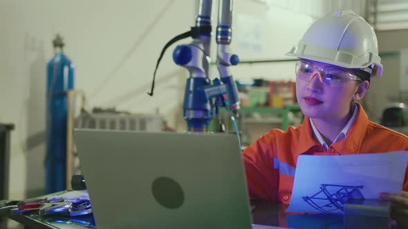 asian female engineer specialist with Measuring machine with a manipulator arm