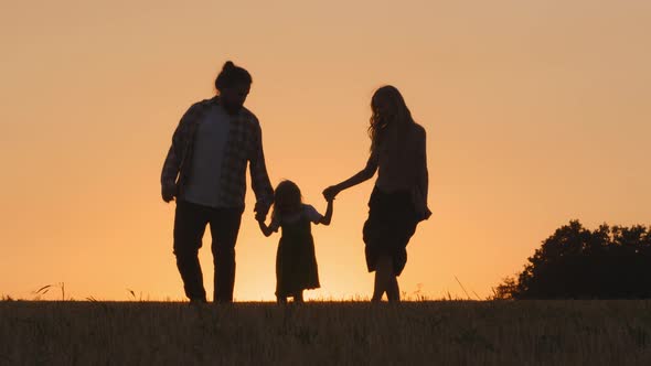 Silhouette of Group of Three People Happy Carefree Family Active Parents with Little Daughter Small