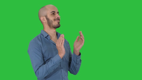 Handsom arab clapping his hands applauding on a Green Screen