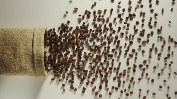 Bag Falls And Coffee Beans Are Poured Out Of It On White Background