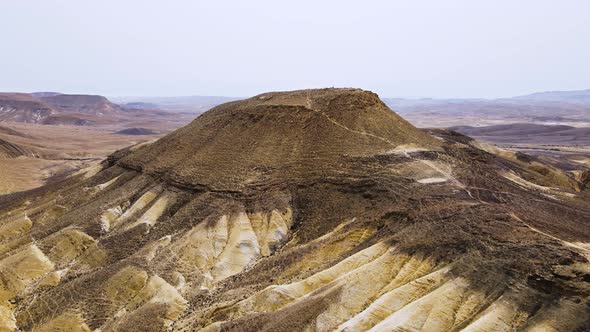 Aerial fly in over Mount Ramon and reveal of the Ramon Crater. This mountain is the tallest in the I