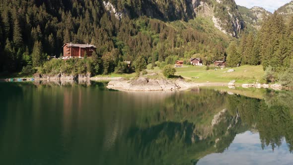 Flying up to beautiful lake shore in Swiss nature