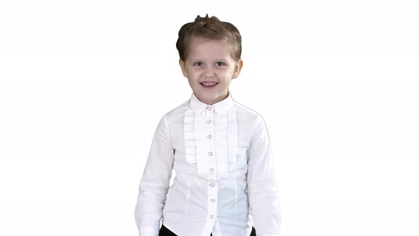 Little Girl Walking and Smiling on White Background.