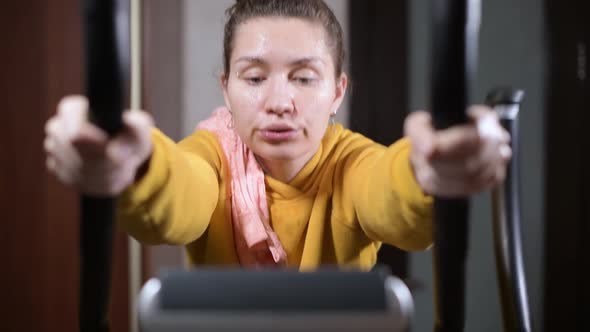 girl loses strength during training and slides down the sport training machine