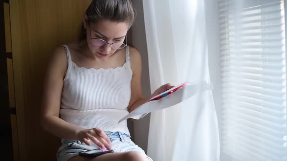 the girl is annoyed that she can t learn how to cross-stitch using the Internet