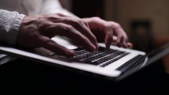 Man Typing on Keyboard of Computer, Close-up. Side View. Shooting in Slow Motion