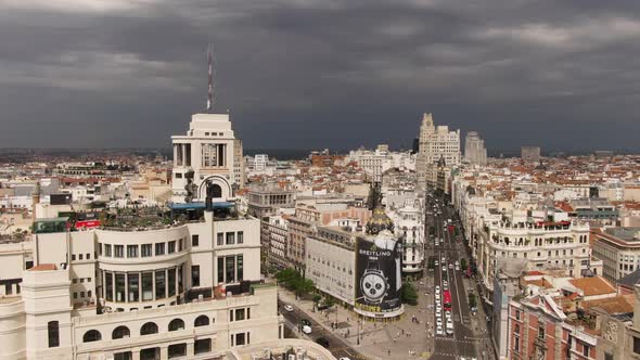 Dark stormy clouds above Madrid city skyline, aerial drone view