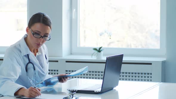 Professional medical doctors working in hospital office making research.