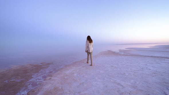 Scenic  Footage of Sensual Brunette Woman Traveler Walking on Pink Lake Barefoot at Evening