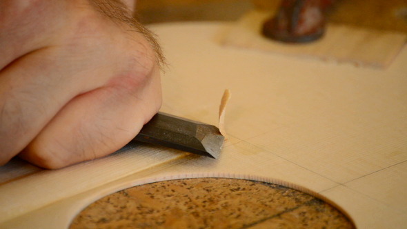 Luthier Working With Chisel in Close Up