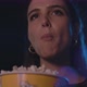 Young woman watching a movie at the cinema and eating popcorn - VideoHive Item for Sale