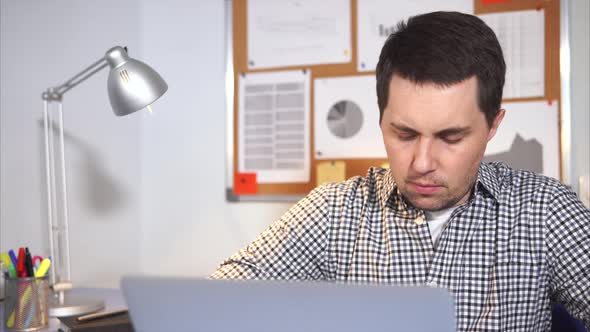 Office Worker Typing at Notebook and Thinking.