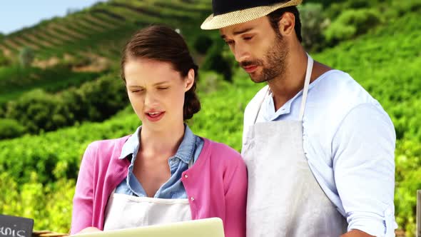 Couple using laptop in farm