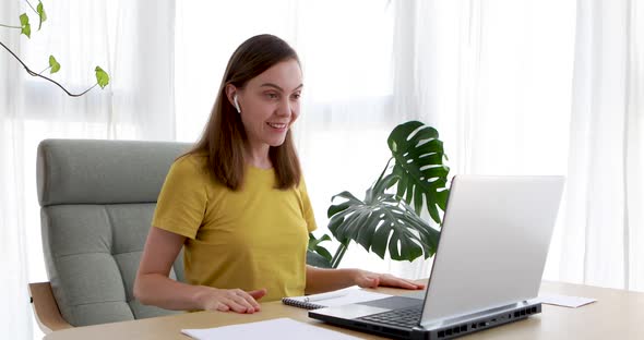 Woman is Speaking on Video Call with Friend Client Colleague Using Laptop Computer