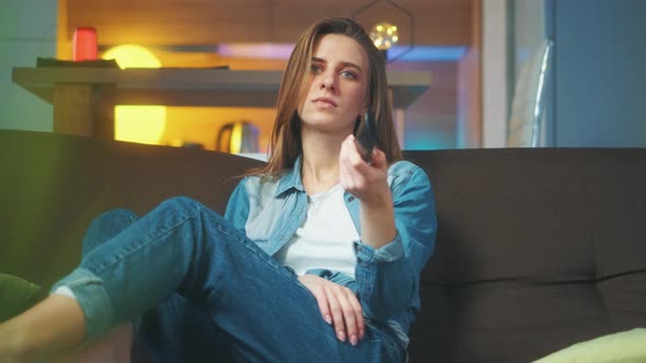 A Young Girl Is Sitting on Sofa