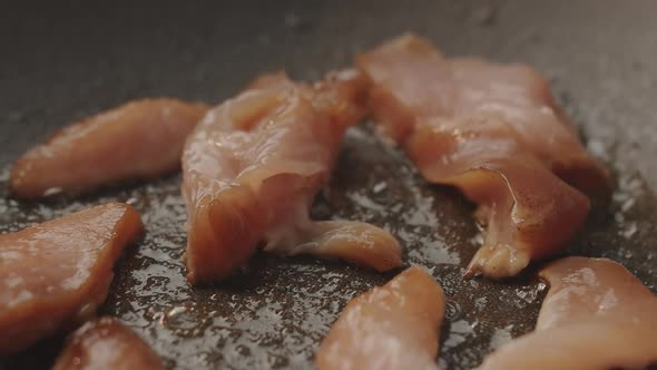 Cooking Chicken in a Pan in the Kitchen