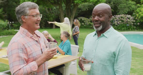 Animation of happy diverse senior male friends talking in garden