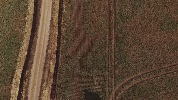 Aerial View Of A Tractor Driving Across The Field