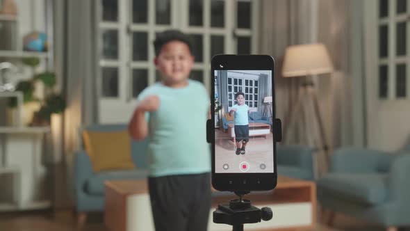 Display Smartphone Of Asian Little Boy Dancing While Shooting Video Content For Social Networks