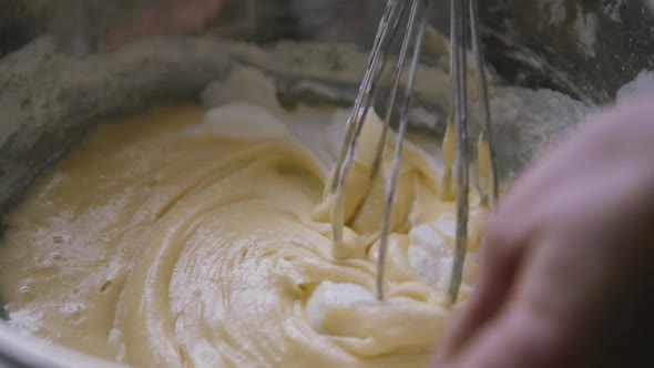 Person Preparing Homemade Omelette Mixing Eggs with Hand Corolla