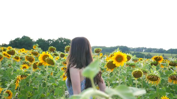 Side View of Carefree Girl Running Through Sunflower Field