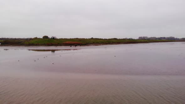 Aerial Flying Over Flood Plain Beside Noord In Ridderkerk. Dolly Back, Pan